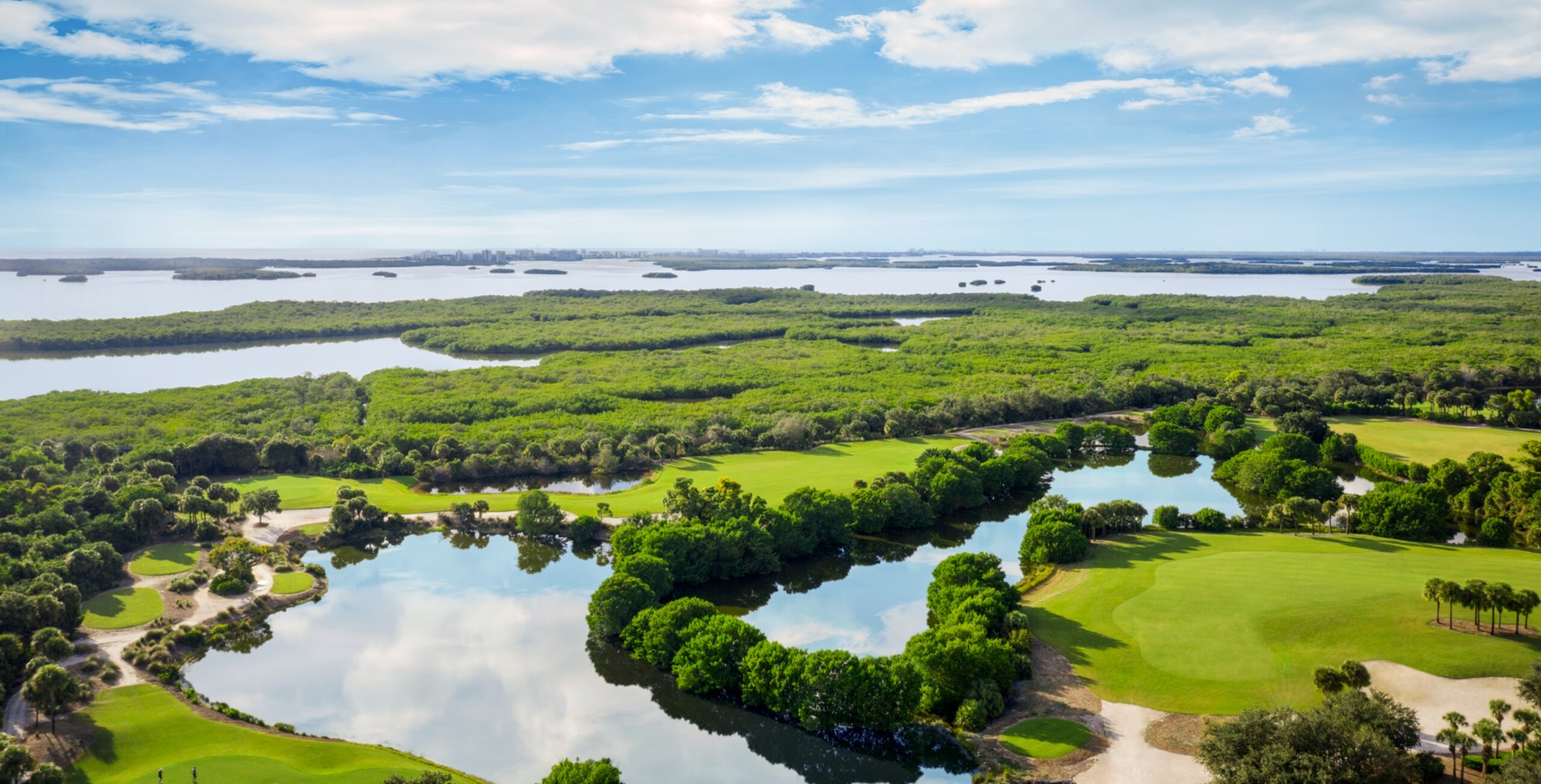 An aerial view of the championship golf course at Saltleaf Golf Preserve in Bonita Springs, with water features throughout.