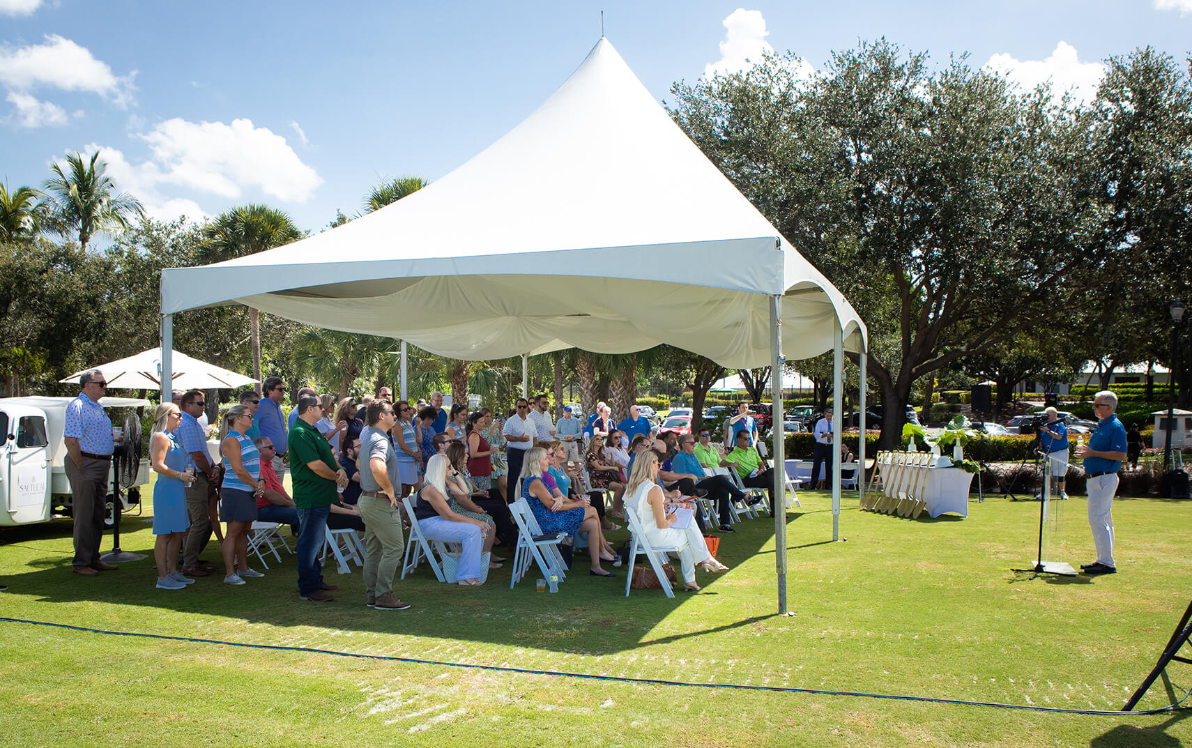 A white tent in the middle of the Saltleaf Golf Preserve, a championship golf course in Bonita Springs.
