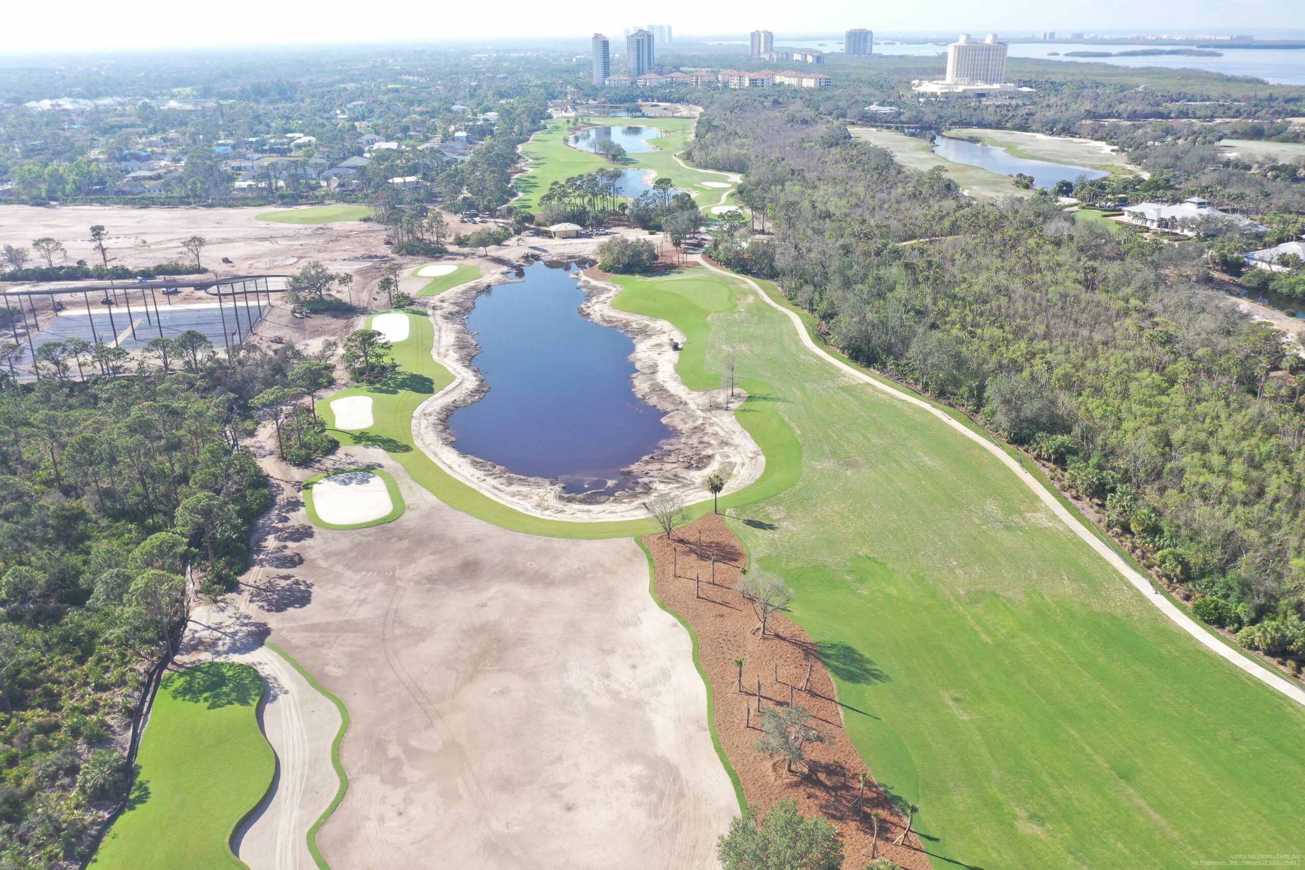 An aerial view of the Saltleaf Golf Preserve, a championship golf course in Bonita Springs, with a serene pond.