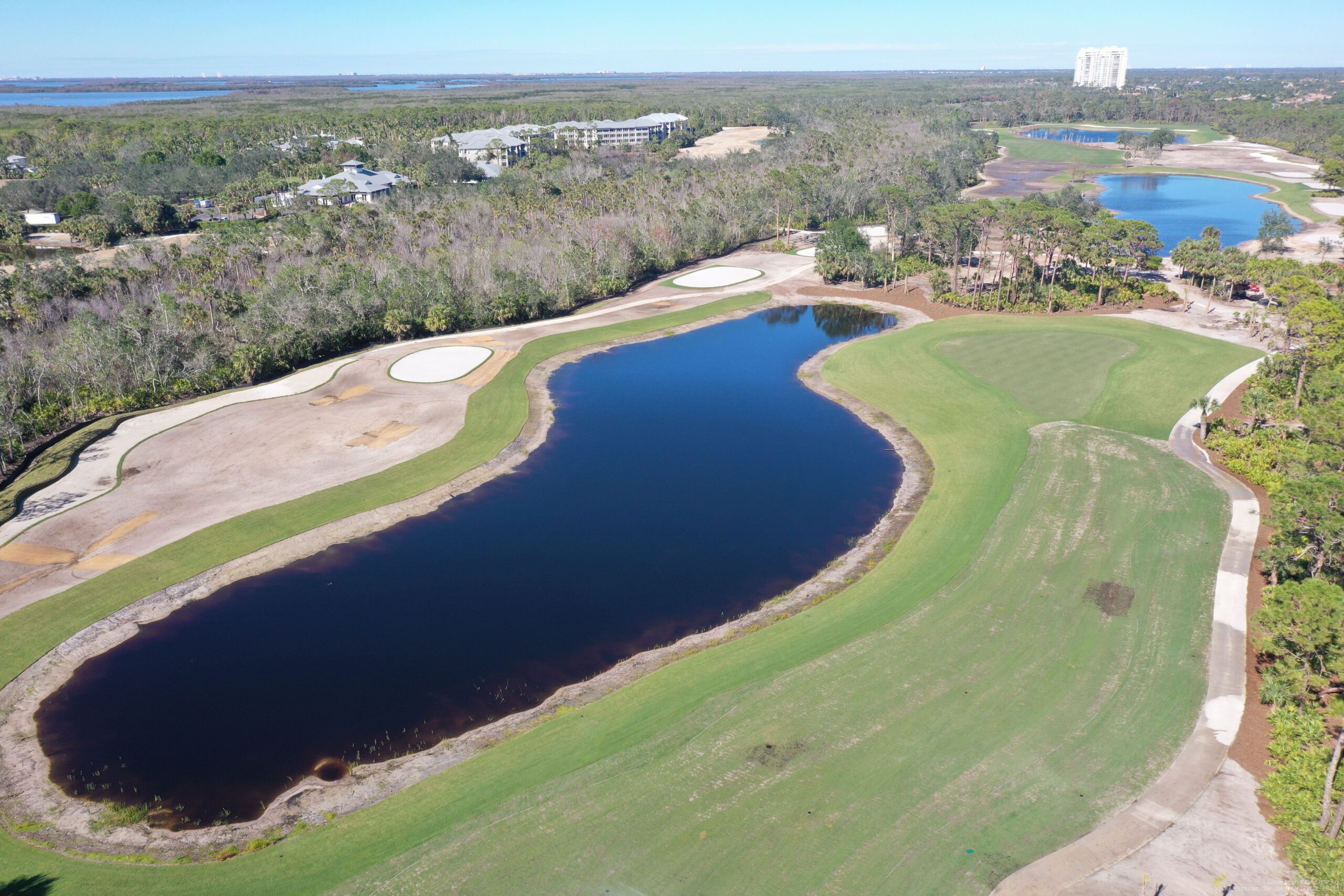 An aerial view of the championship golf course at Saltleaf Golf Preserve in Bonita Springs, with a pond.