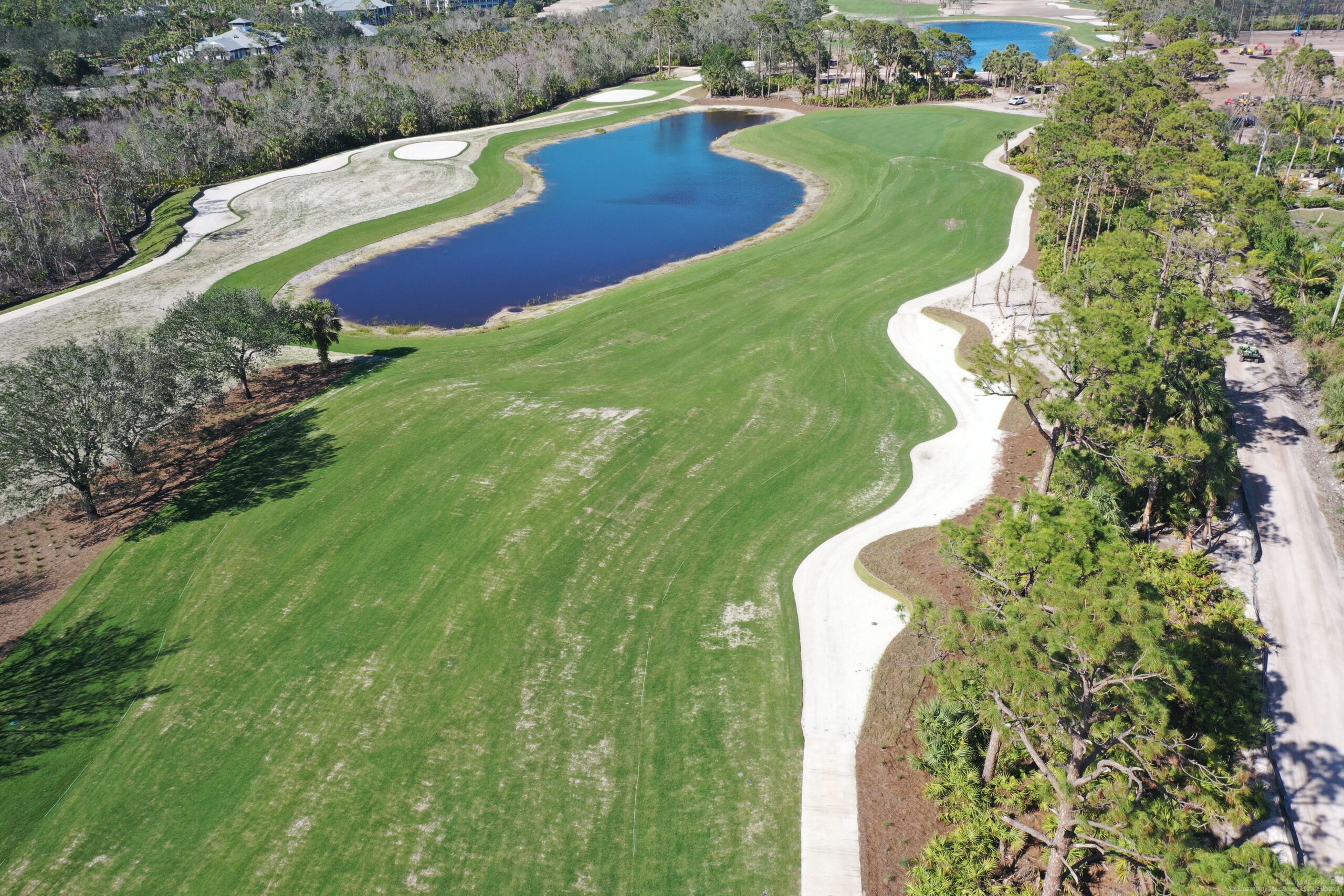 An aerial view of Saltleaf Golf Preserve, a championship golf course in Bonita Springs, with a pond.