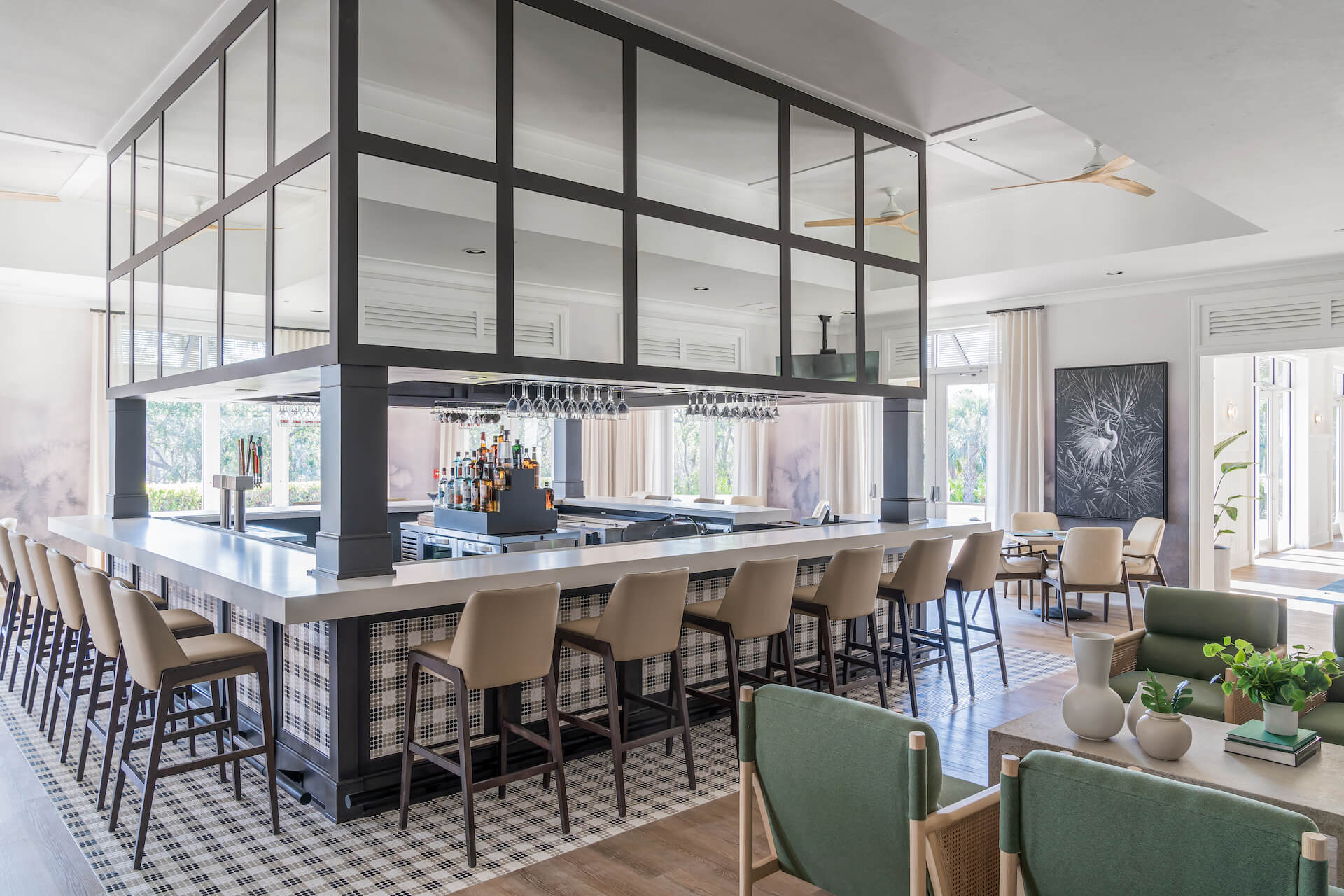 Modern kitchen and bar with seating at the restaurant within the clubhouse at Saltleaf Golf Preserve