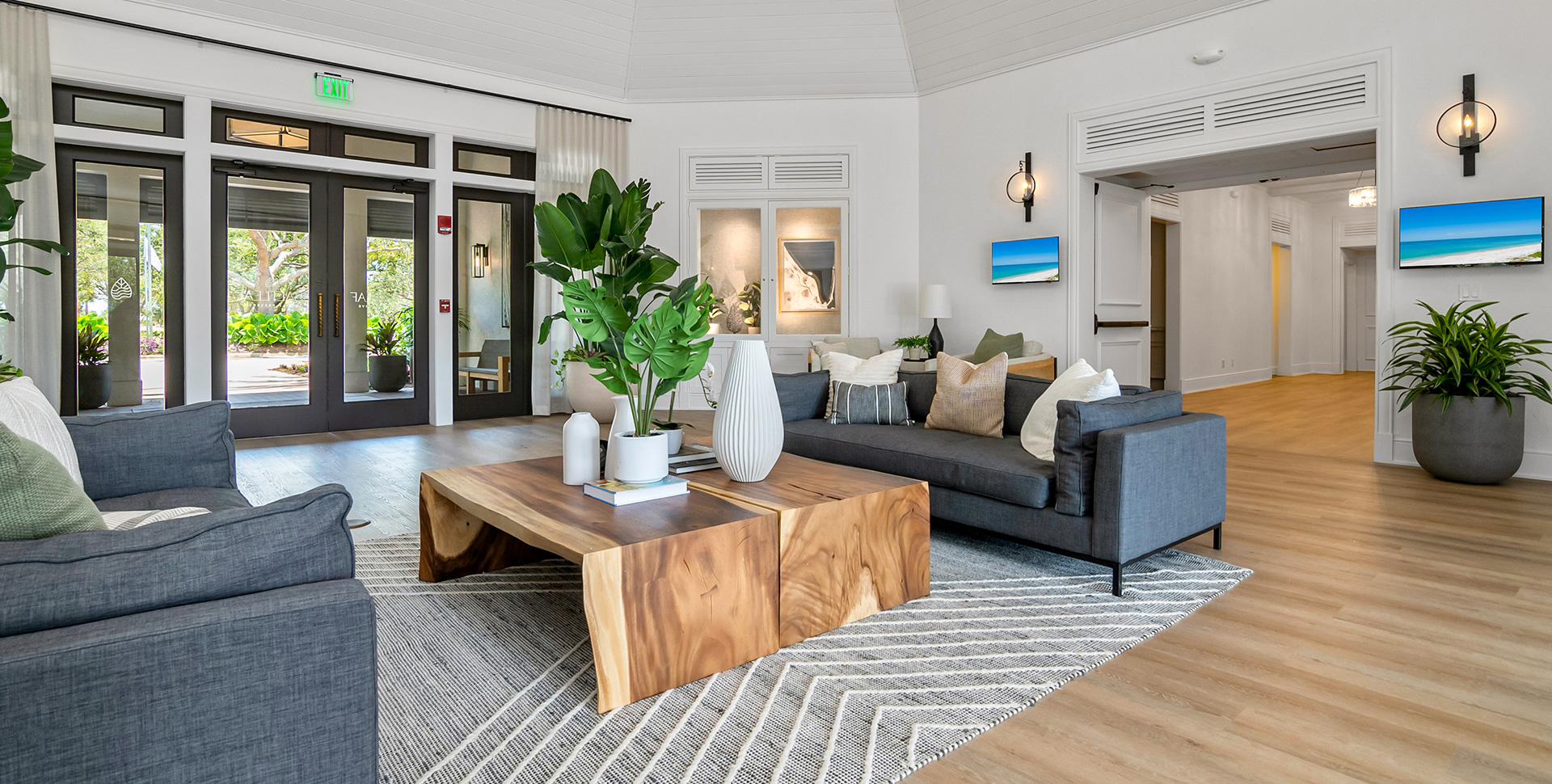A living room with couches and a coffee table located in Bonita Springs, overlooking the beautiful Saltleaf Golf Preserve.
