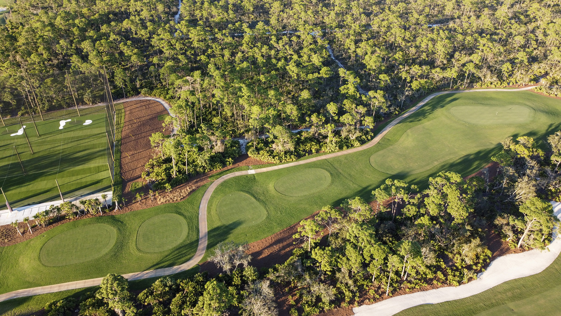 An aerial view of the Saltleaf Golf Preserve, a championship golf course in Bonita Springs, surrounded by trees.